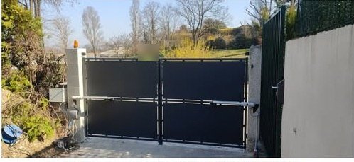 Portail acier vu de l'intérieur avec ses bras de motorisation
